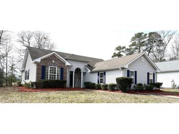 Charming single-story home with manicured landscaping and a welcoming entrance at 4333 Oakwood Circle, Little River, SC 29566