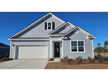 Charming home featuring light-blue siding, a garage, and a black front door at 501 Haven View Way, Murrells Inlet, SC 29576