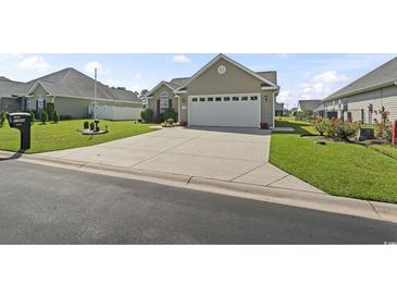 Charming single-story home featuring a well-manicured lawn and a spacious two car attached garage at 1068 Lizzie Ln., Surfside Beach, SC 29575