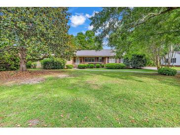 Charming single-story home featuring a well-maintained lawn and mature trees creating curb appeal at 1305 Forest View Rd., Conway, SC 29526