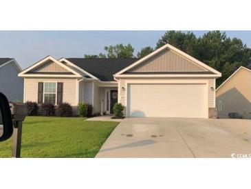 Charming single-story home with neutral siding, well-manicured lawn, and attached two-car garage at 387 Blue Rock Dr., Longs, SC 29568