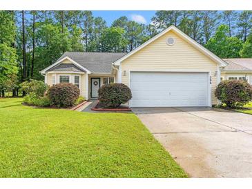 Charming yellow single-story home with a manicured lawn and attached two-car garage at 396 Mckendree Ln., Myrtle Beach, SC 29579
