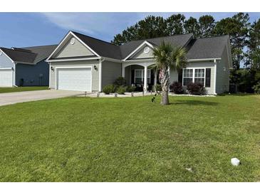 Well maintained one-story home featuring a manicured front yard with fresh green grass and landscaping at 541 Irees Way, Longs, SC 29568