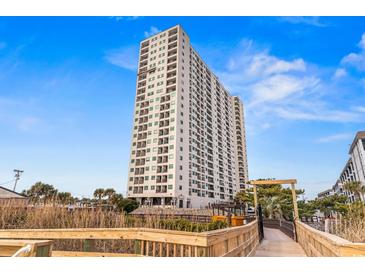 Expansive view of the oceanfront building with beach access from private wooden walkway at 5905 S Kings Highway # 1206-C, Myrtle Beach, SC 29575