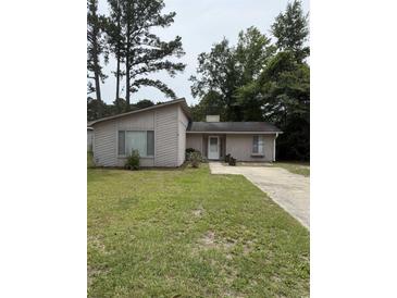 Charming single-story home with a well-maintained lawn and a long driveway at 615 Todd Blvd., Conway, SC 29526
