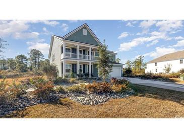Charming two-story home with manicured landscaping and a welcoming front porch at 709 Rupert Dr, Conway, SC 29526