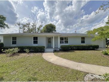 Charming single-story home with a brick facade, well-manicured lawn, and a inviting walkway at 7611 Coteswood Dr., Myrtle Beach, SC 29572