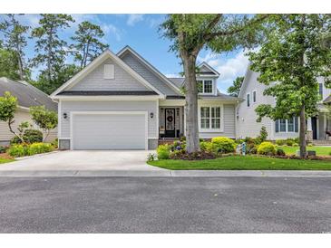Charming single-Gathering home showcasing a well-manicured lawn, inviting curb appeal, and an attached two-car garage at 816 Morrall Dr., North Myrtle Beach, SC 29582