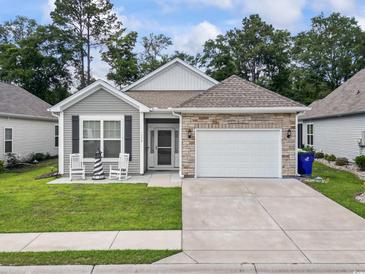 Charming single-story home featuring a stone accented garage, rocking chairs, and a well-manicured lawn at 1178 Pyxie Moss Dr., Little River, SC 29566