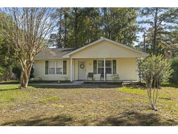Charming single-story home with a manicured lawn and welcoming front porch at 1300 Ragin St., Myrtle Beach, SC 29577