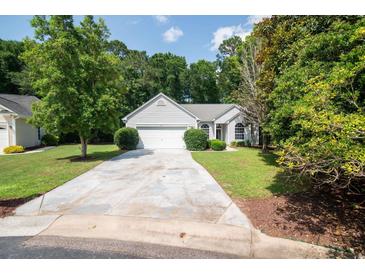 Charming single-story home boasts a well-manicured lawn and a long, inviting driveway at 161 Patriot Ln., Pawleys Island, SC 29585