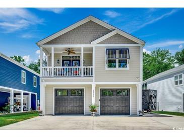 Charming two-story home with a welcoming front porch and dual garage doors at 1737 24Th Ave. N, North Myrtle Beach, SC 29582