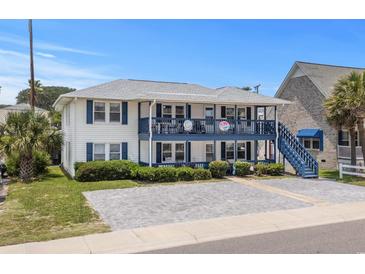 Charming two-story beach house with blue accents, inviting balconies, and well-maintained landscaping at 2006 S Ocean Blvd., North Myrtle Beach, SC 29582