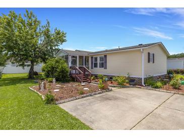 Well-maintained home features a beautiful landscaped yard and a welcoming front entrance, perfect for curb appeal at 259 Iroquis Trail, Longs, SC 29568