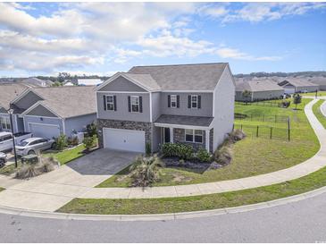 Beautiful gray two-story home featuring a spacious front yard and an attached two-car garage at 2989 Skylar Dr., Myrtle Beach, SC 29577