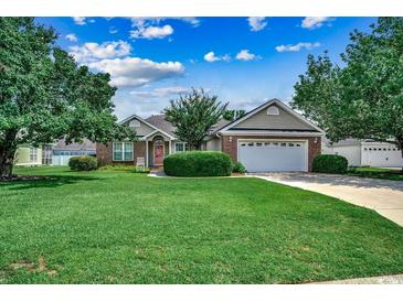 Charming single-story home boasts a well-manicured lawn and mature trees at 303 Ayrie Ct., Conway, SC 29527
