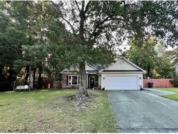 Charming single-story home with a well-maintained lawn and mature trees at 3048 Dewberry Dr., Conway, SC 29527