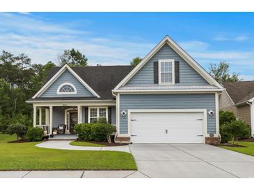 Charming single-Gathering home with blue siding, well-manicured lawn, and two-car garage in a friendly neighborhood at 341 Bahama Dr., Murrells Inlet, SC 29576