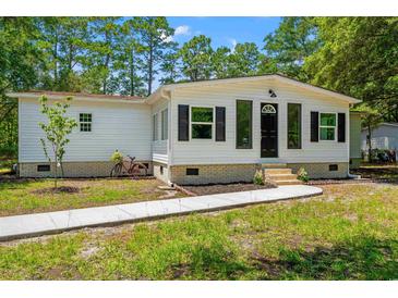 Charming single-story home with white siding, black shutters, and a well-manicured front yard at 5074 Cowart Ct., Murrells Inlet, SC 29576