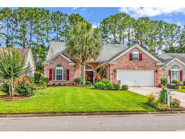 Charming brick home with a manicured lawn, mature trees, and an attached two-car garage at 6434 Longwood Dr., Murrells Inlet, SC 29576