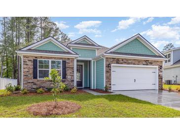 Inviting exterior featuring stone accents, turquoise siding, and a well-manicured lawn at 725 Doonbeg Ct., Conway, SC 29526