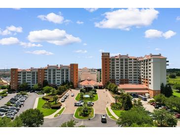 Stunning hotel exterior with lush landscaping, fountain, grand entrance, and ample parking on a sunny day at 8121 Amalfi Pl. # 4-1006, Myrtle Beach, SC 29572