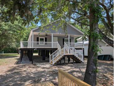 Charming raised beach house with gray siding, white railings, and inviting front porch at 1022 Waccamaw Dr., Conway, SC 29526