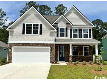 Charming two-story home with stone accents, gray siding, well-maintained lawn, and two-car garage at 135 Stride Ct., Myrtle Beach, SC 29588