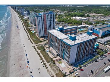 Stunning aerial view of the oceanfront resort, showcasing the beach, pools, and modern high-rise buildings at 1501 S Ocean Blvd. # 1422, Myrtle Beach, SC 29577