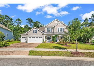 Inviting two-story home with a three-car garage, well-manicured lawn, and charming front porch at 1662 Westminster Dr., Myrtle Beach, SC 29577
