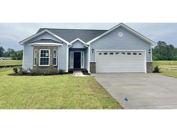 Charming single-story home with blue siding, stone accents, and a well-maintained lawn at 181 Norris Ln, Loris, SC 29569