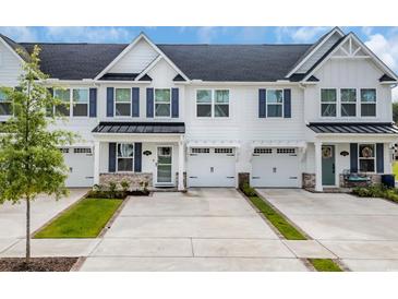 Charming townhouse exterior with white siding, blue shutters, and well-manicured landscaping at 2352 Elowen Ln. # 22B, Longs, SC 29568