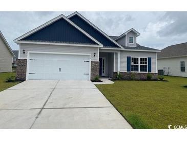 Charming single-story home with a two-car garage, well-manicured lawn, and welcoming curb appeal at 434 Lifestyle Court, Surfside Beach, SC 29575
