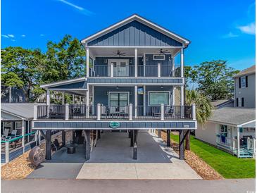 Beautiful, elevated beach house with double decks, outdoor entertainment space, and ample parking at 6001- Q10 S Kings Hwy., Myrtle Beach, SC 29575