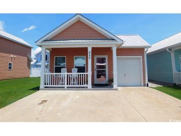 Charming single-story home featuring a welcoming front porch, tidy yard, and an attached single-car garage at 620 Wave Rider Ln. # B10-1, North Myrtle Beach, SC 29582