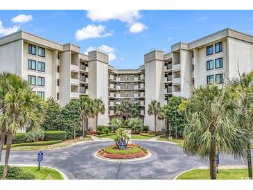Beautiful condo complex with meticulously landscaped entrance and mature palm trees at 741 Retreat Beach Circle # B-1-A, Pawleys Island, SC 29585