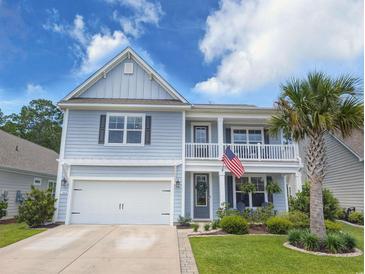 Charming two-story home with a welcoming front porch, a two-car garage, and well-maintained landscaping at 748 Old Murrells Inlet Rd., Murrells Inlet, SC 29576