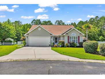 Charming single-story home with a well-manicured lawn, a two-car garage, and mature trees at 824 Dunoway Ct., Myrtle Beach, SC 29579