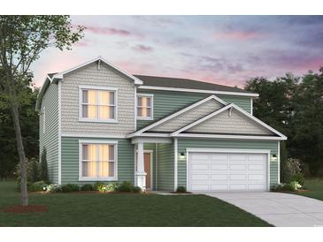 Charming two-story home with a two-car garage, green siding, and landscaped front yard at 8644 Farrier Dr., Myrtle Beach, SC 29588
