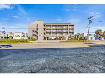 Condo building with beachy vibes and covered parking underneath; convenient for guests and residents at 120 Dogwood Dr. N # 313, Garden City Beach, SC 29576