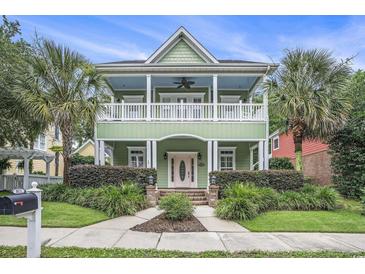 Two-story home with double porches, a well-maintained lawn, and lush landscaping at 1613 James Island Ave., North Myrtle Beach, SC 29582
