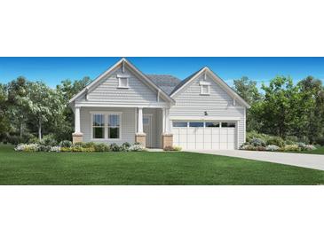 Charming single-story home with white siding, columned porch, well-manicured lawn and 2 car garage at 2071 Comradery Way, Murrells Inlet, SC 29576