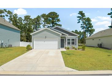Charming one-story home with attached garage, well-manicured lawn, and lovely landscaping at 228 Averyville Dr., Conway, SC 29526