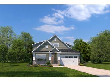 Charming two-story home featuring stone accents, neutral siding, a two-car garage, and a beautifully landscaped front yard at 2353 Hazel Way, Longs, SC 29568