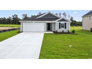 Charming single-story home with well-manicured lawn and attached one car garage at 24 Cape Point Dr., Conway, SC 29527