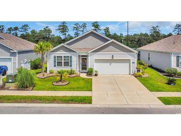 Charming single-story home boasts a well-manicured lawn and a welcoming two-car garage at 2882 Ophelia Way, Myrtle Beach, SC 29577