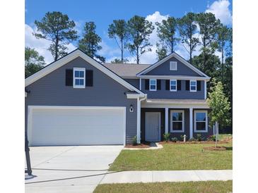 Charming two-story home featuring a two-car garage, symmetrical windows and black shutters and freshly sodded lawn at 331 Rivers Edge Dr., Myrtle Beach, SC 29588