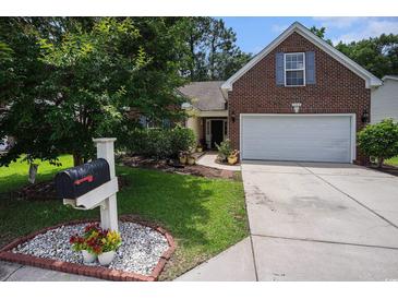 Charming single-Gathering home featuring brick accents, a well-maintained yard, and a two-car garage at 364 Vesta Dr., Myrtle Beach, SC 29579