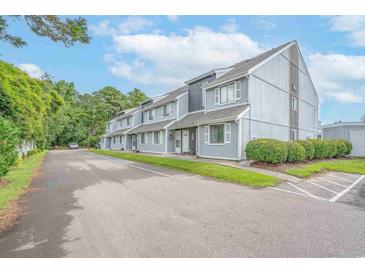 Charming multi-Gathering building featuring a well-maintained yard and ample parking spaces at 3700 Golf Colony Lane # 26A, Little River, SC 29566