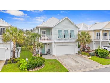 Charming two-story beach home featuring palm trees, a front porch, and a two-car garage at 540 Chanted Dr., Murrells Inlet, SC 29576